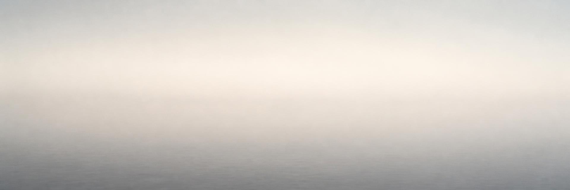 A calm, minimalist landscape in early morning light